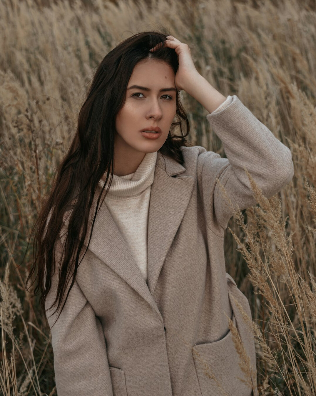 Portrait of a German woman in her forties with dark hair in a tailored blazer