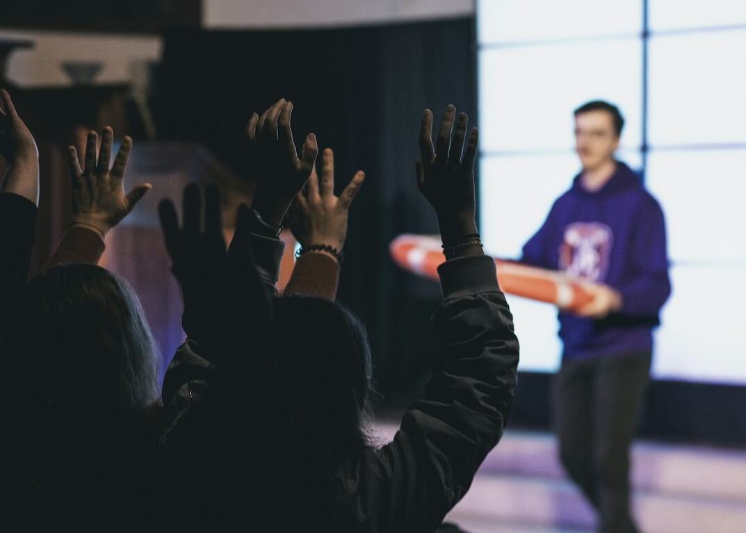 leader on stage with audience